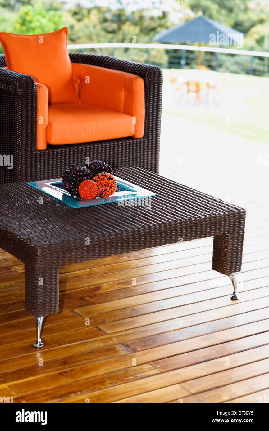 Table and an armchair on the patio Stock Photo - Alamy