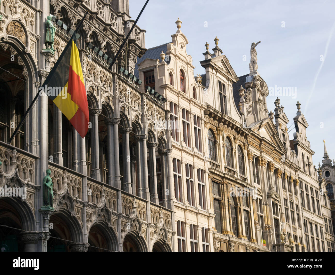 17th century historic facades on the Brussels Grand market square, Belgium, with Belgian flag. Stock Photo