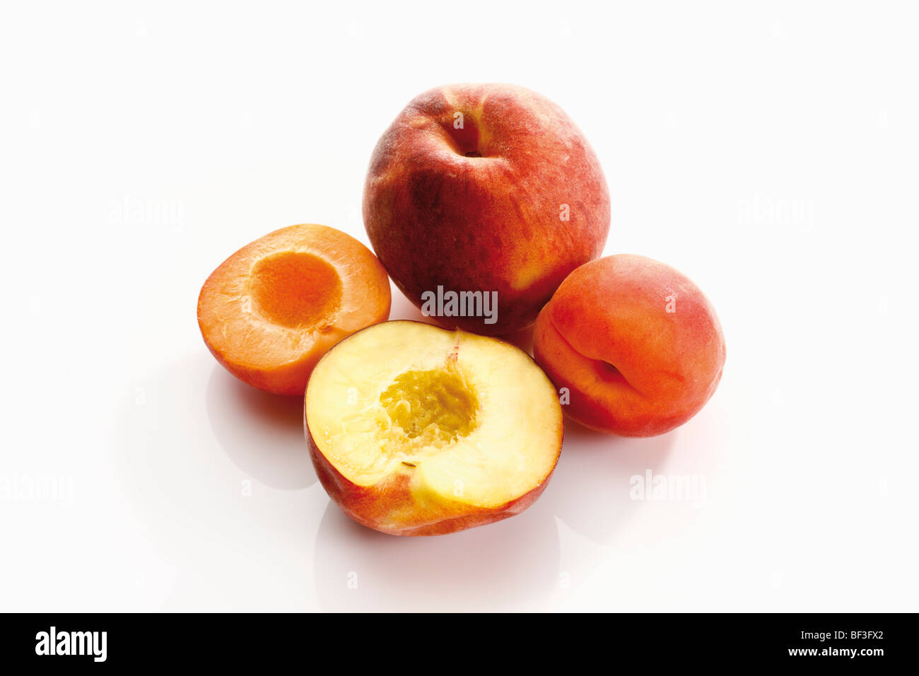 Apricot and peach, whole and halved Stock Photo Alamy