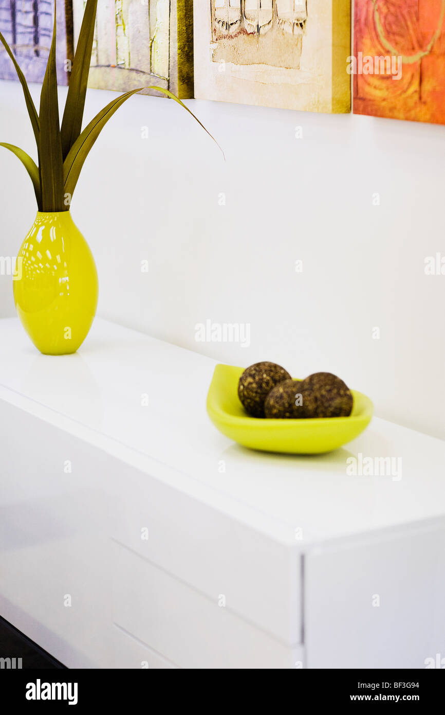 Vase with decorative balls on a sideboard Stock Photo Alamy