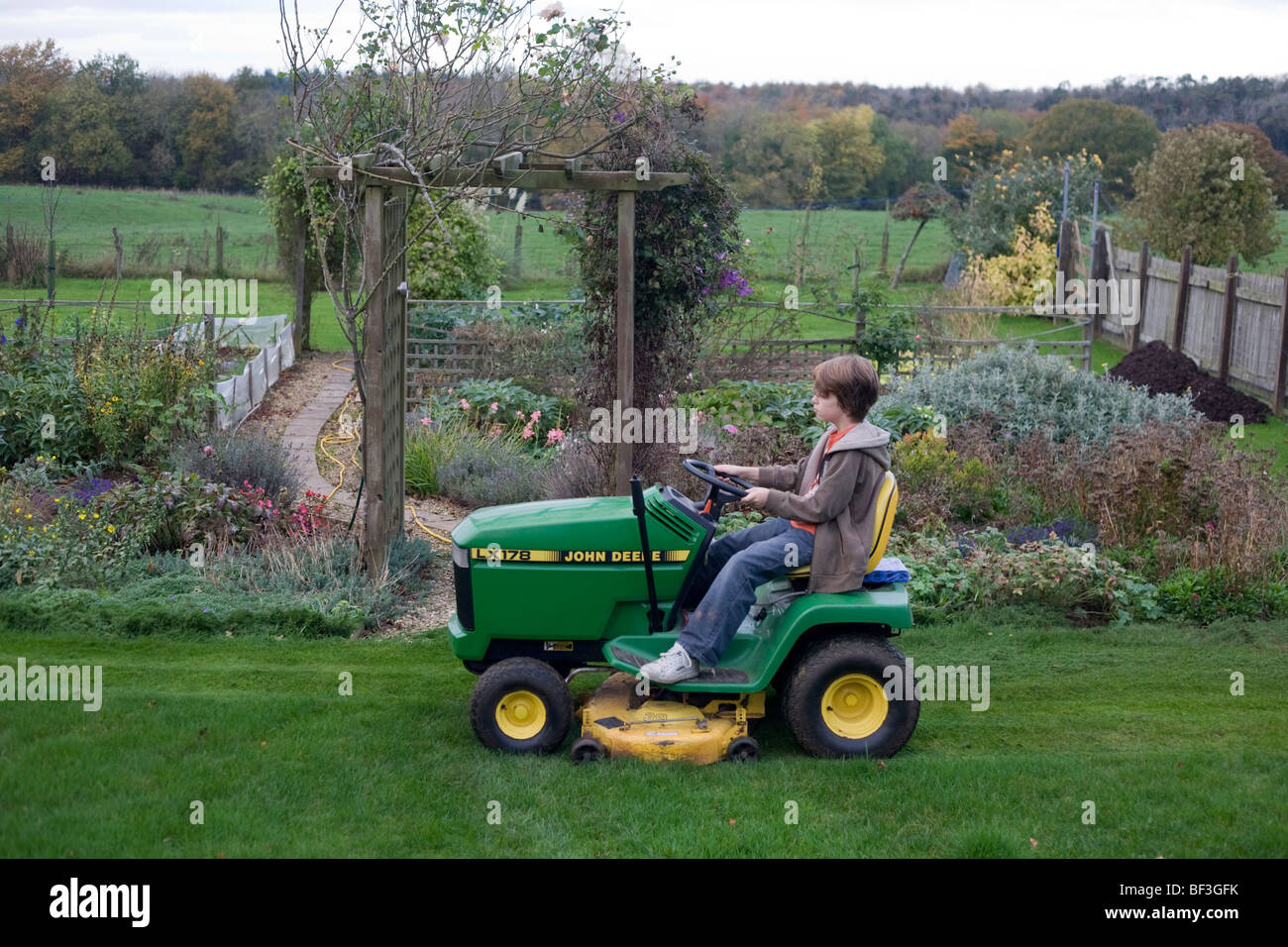 An eleven year old boy drives his grandfather s lawn mower tractor