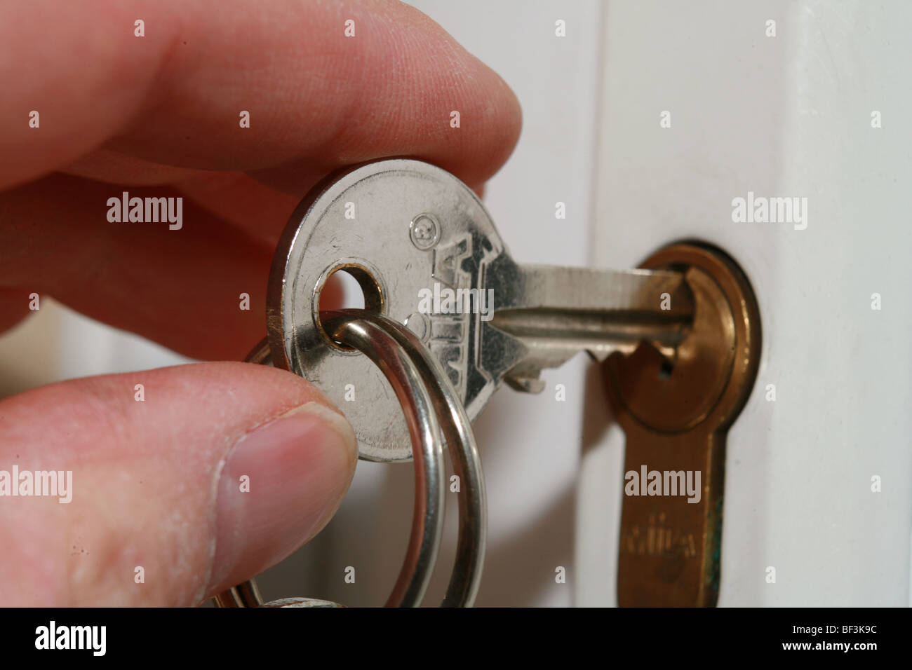 close up of key inserted into lock Stock Photo