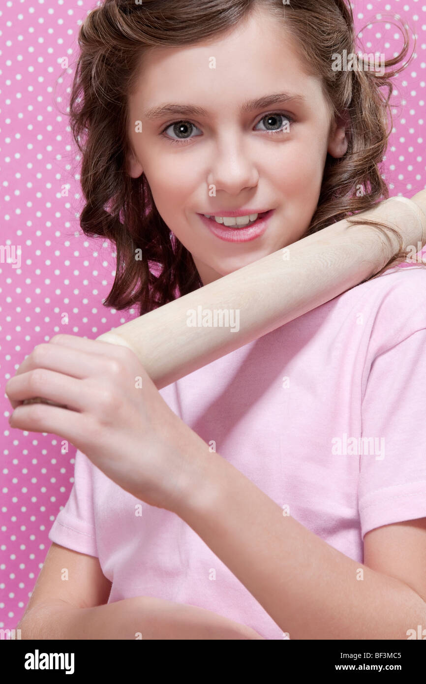 Girl holding a rolling pin on her shoulders Stock Photo Alamy