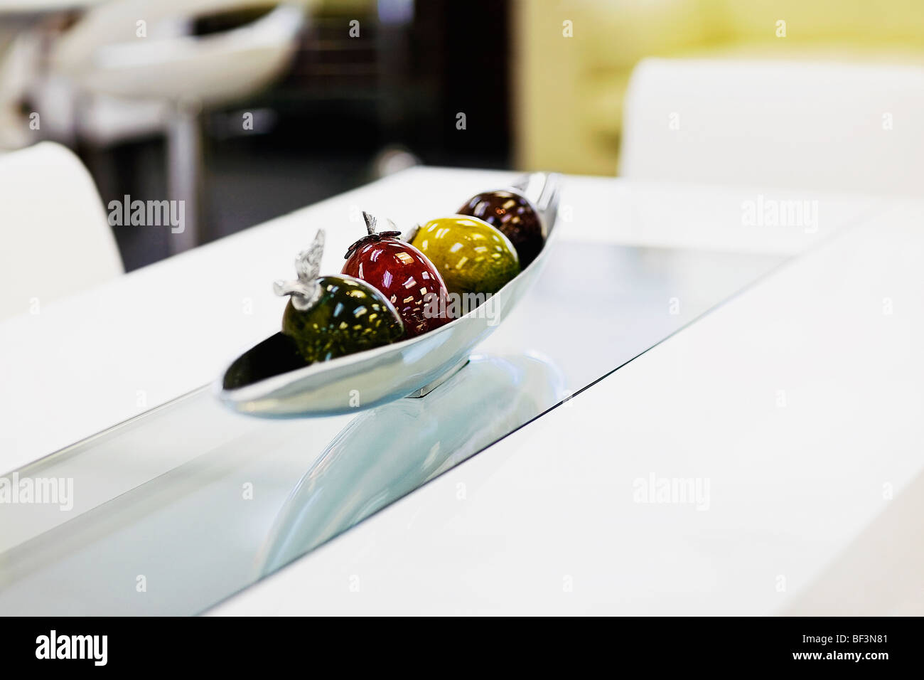 Artificial fruits in a bowl on a dining table Stock Photo Alamy