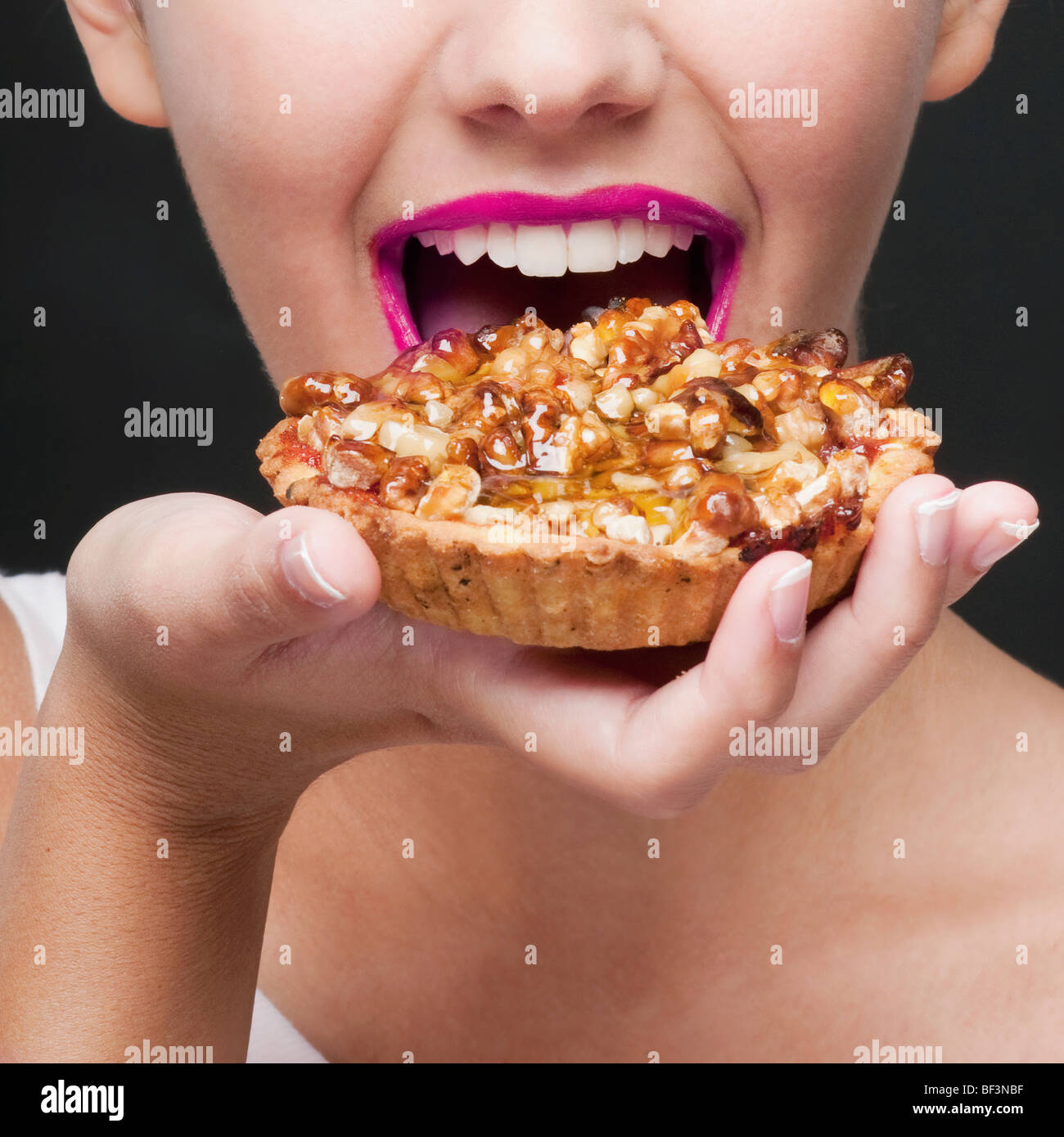 Closeup of a woman eating a tart Stock Photo Alamy