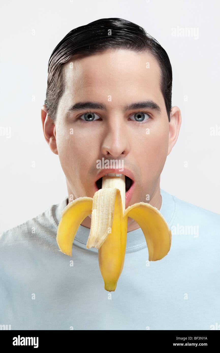 Portrait of a man eating a banana Stock Photo Alamy