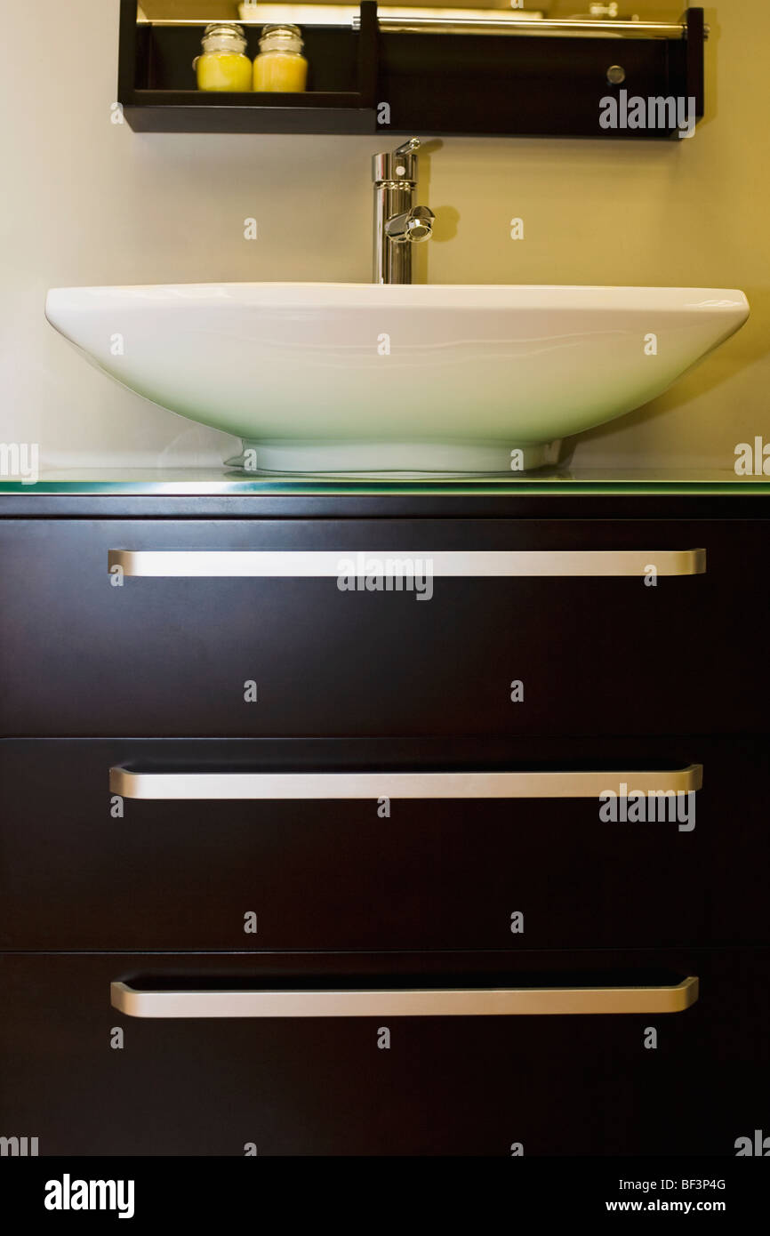 Wash bowl on a cabinet in the bathroom Stock Photo