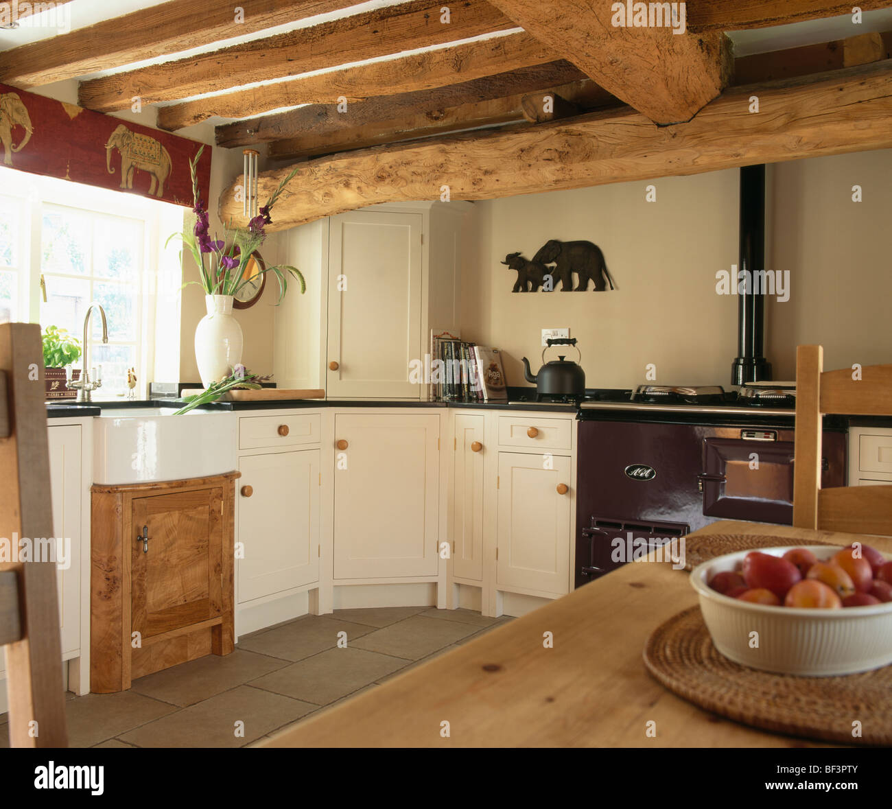 Beamed Ceiling In Traditional Country Cottage Kitchen With Purple