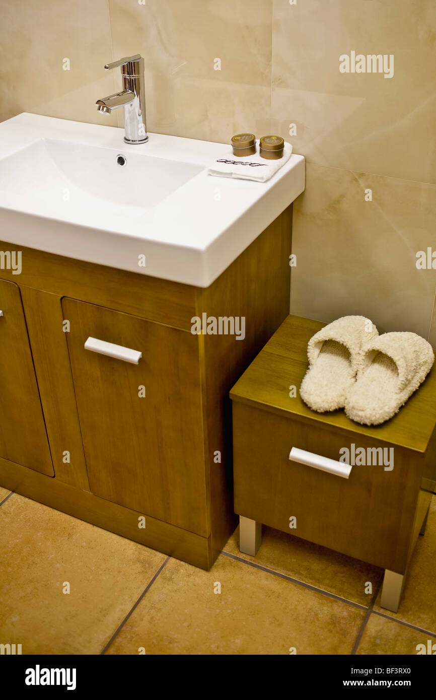 Slipper on a cabinet near a washbasin Stock Photo