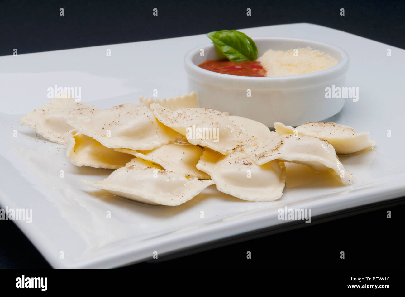 High angle view of ravioli served with tomato sauce and grated cheese Stock Photo