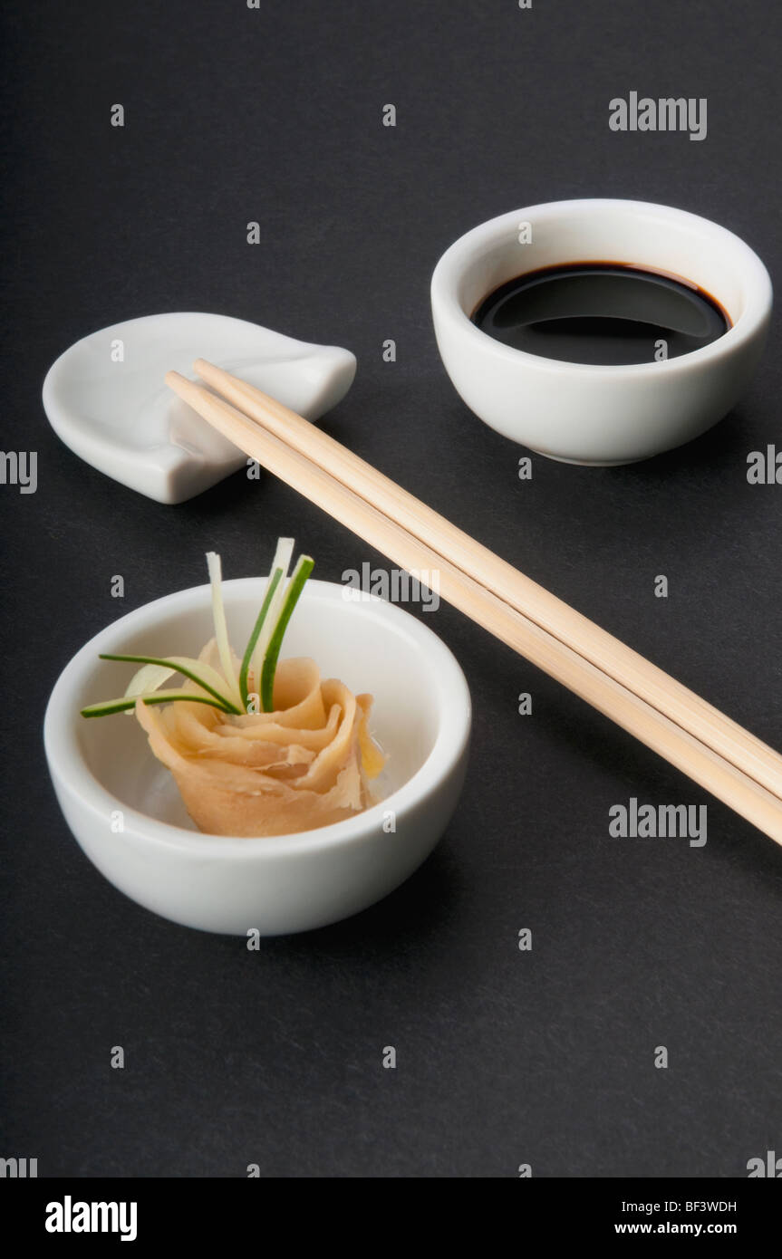 Close-up of chopsticks with soy sauce and pickled ginger Stock Photo