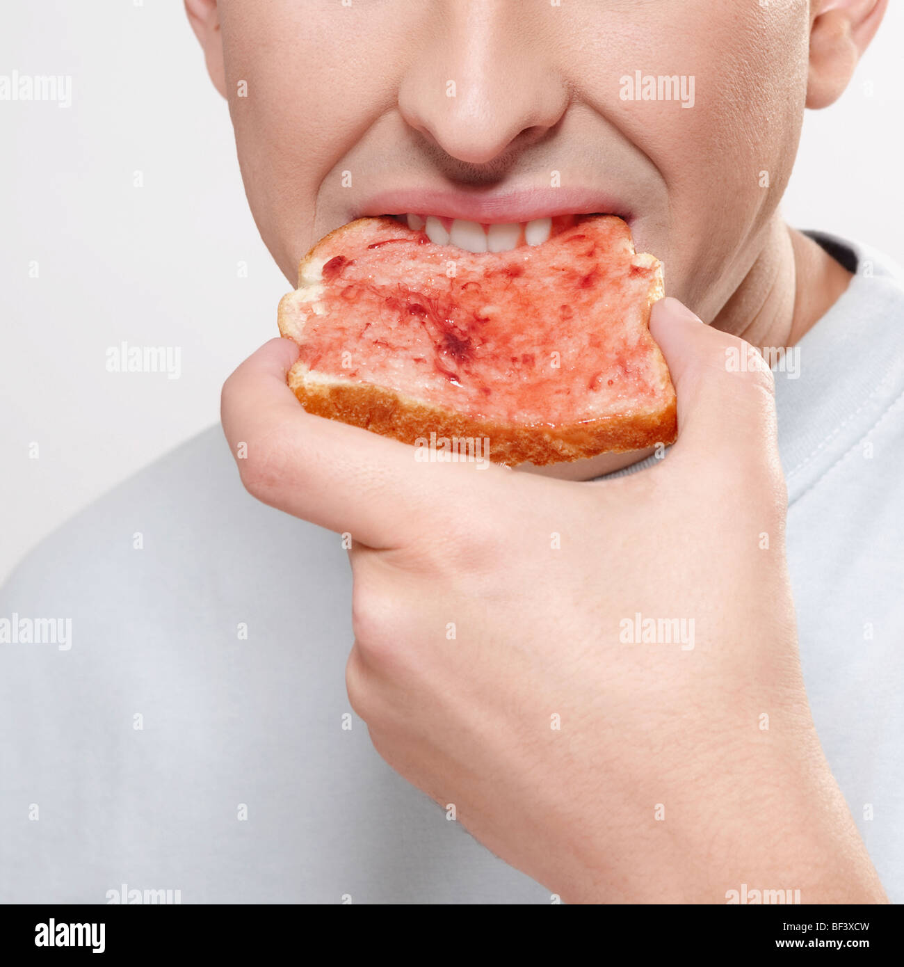 Man eating jam on toast Stock Photo Alamy