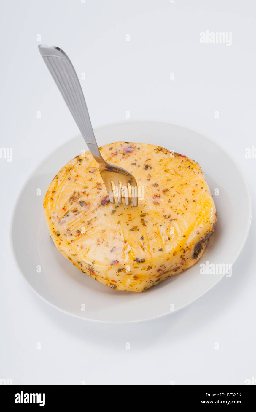 Close up of grilled provolone cheese garnished with oregano hires