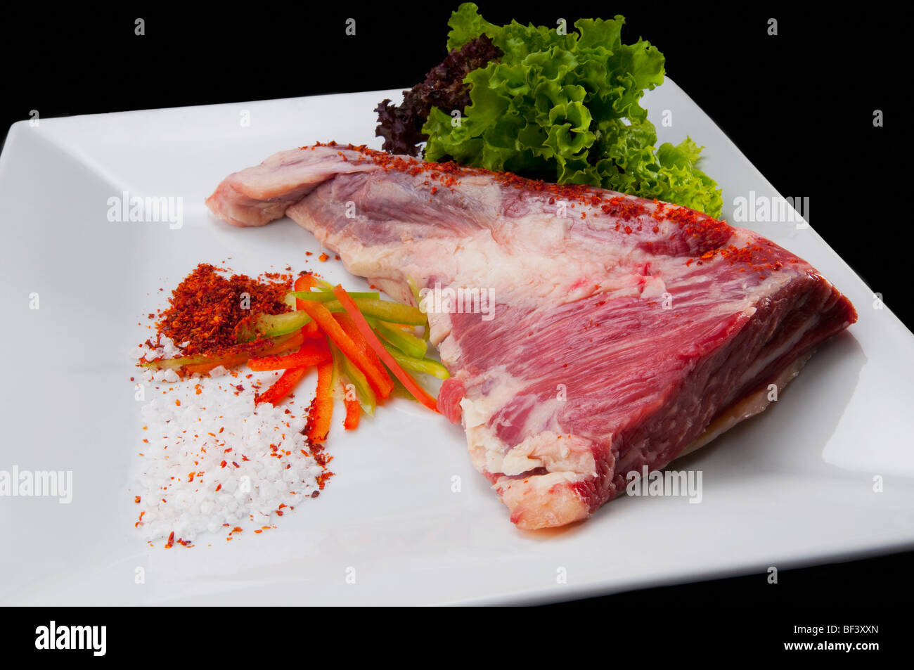 Close-up of a steak with ground red chilies and peppers Stock Photo