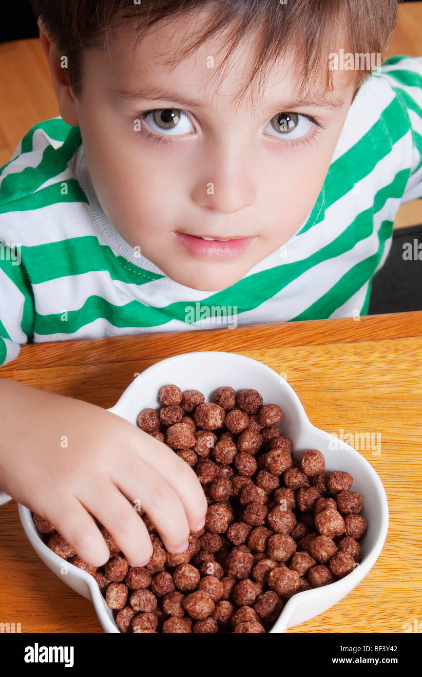 Closeup of a boy eating dry cereal Stock Photo Alamy