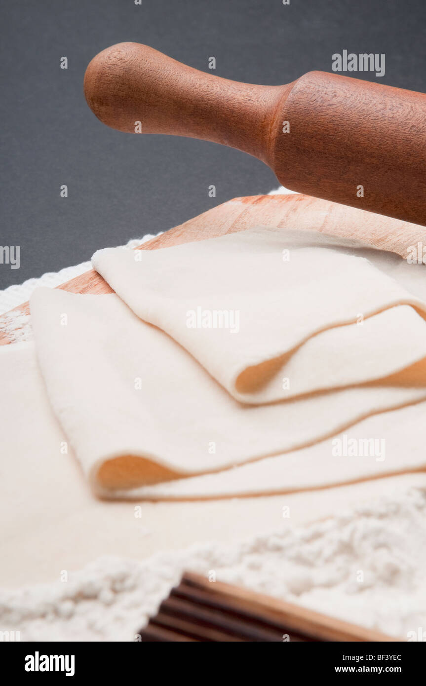 Close up of dough with mould and a rolling pin hires stock photography