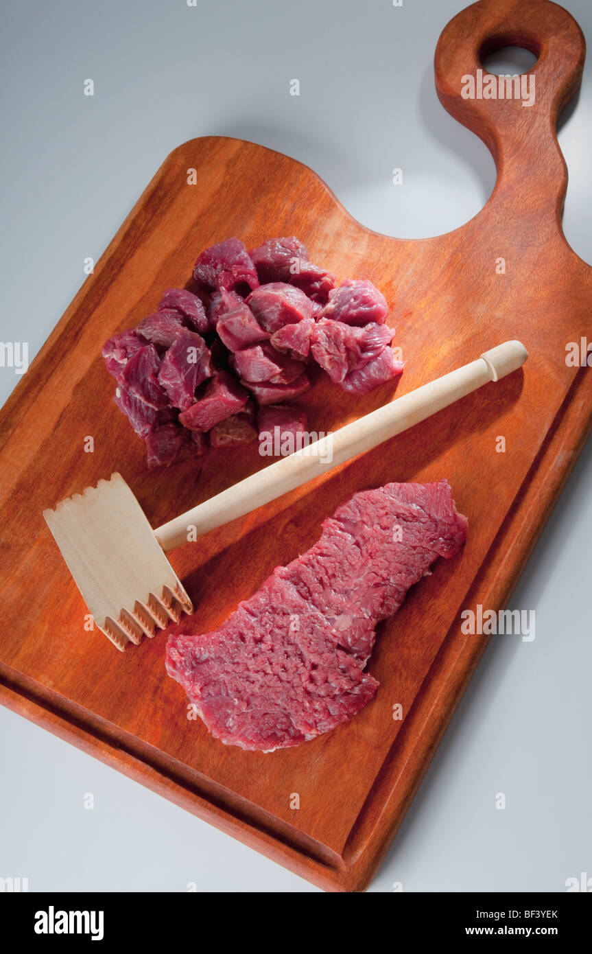Close-up of meat cubes with a meat tenderizer Stock Photo