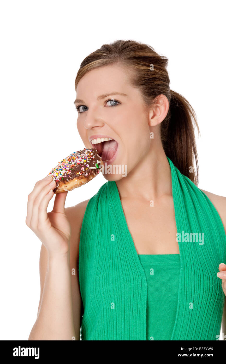 Cute Caucasian woman eating a donut on a white background Stock Photo