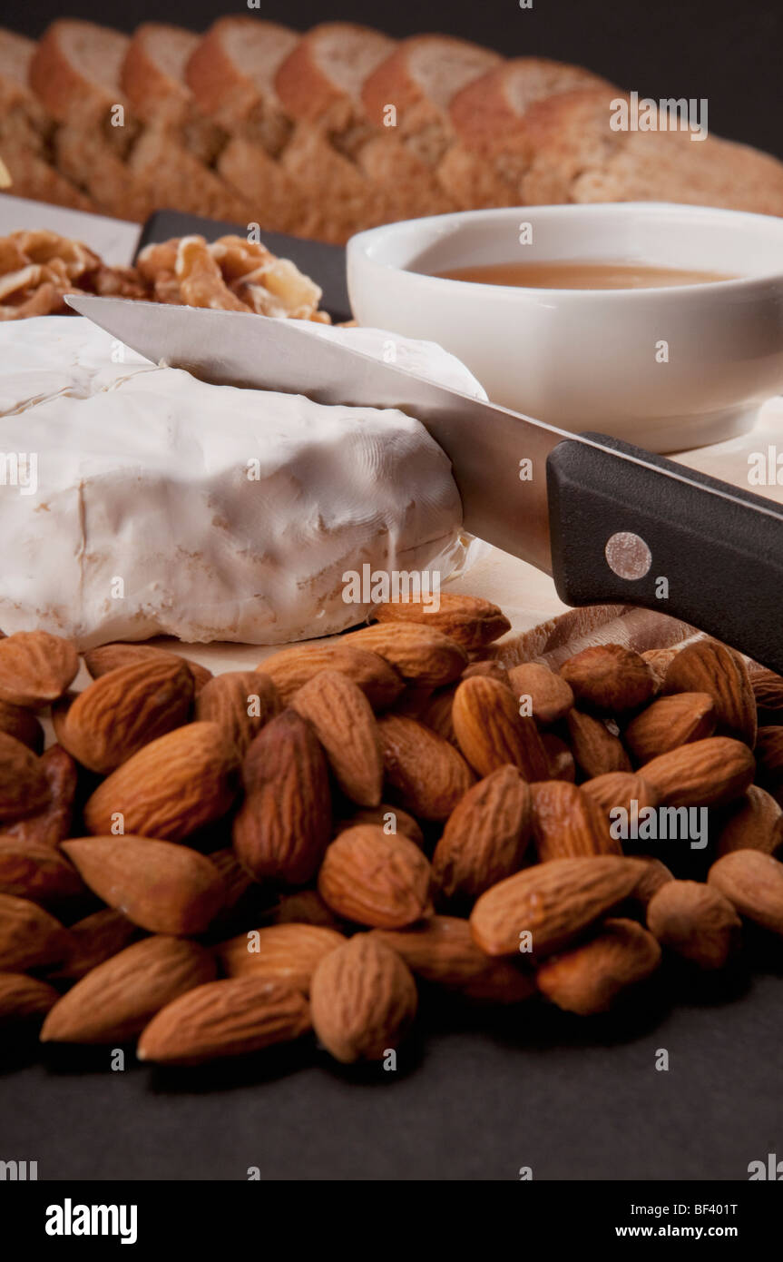 Brie served with dry fruits and bread Stock Photo
