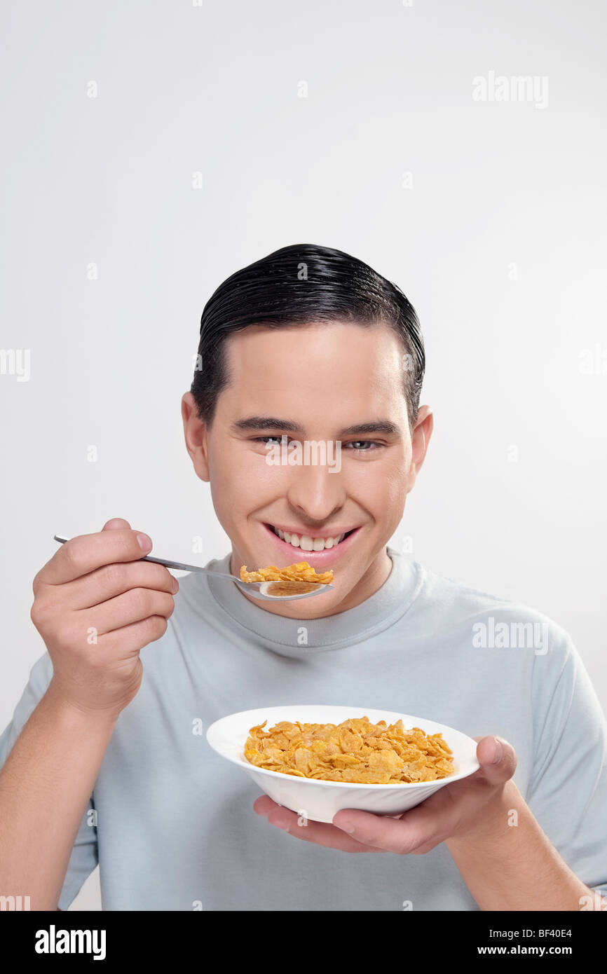 Man eating corn flakes Stock Photo Alamy