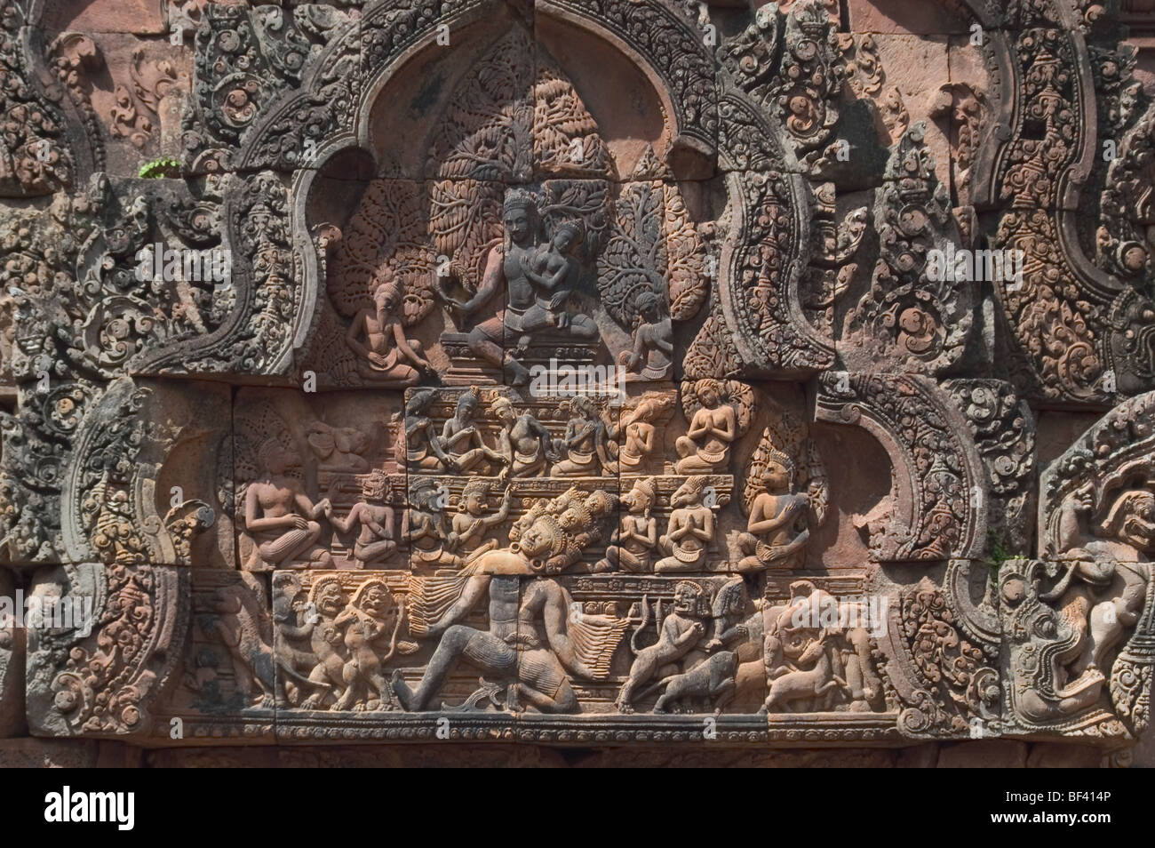 Detail from Banteay Srei, the citadel of the women or beauty, famed for its intricate red sandstone carvings of mythical creatures like Kala. Stock Photo
