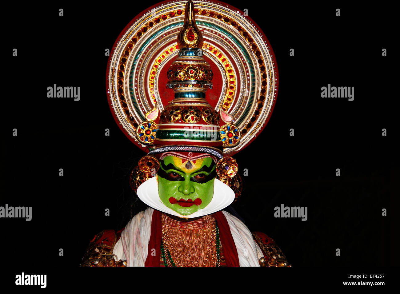 kathakali,portrait,colored face,indian,dance drama,crown,red eyes,red lips,greenish face,tribal,colored Stock Photo