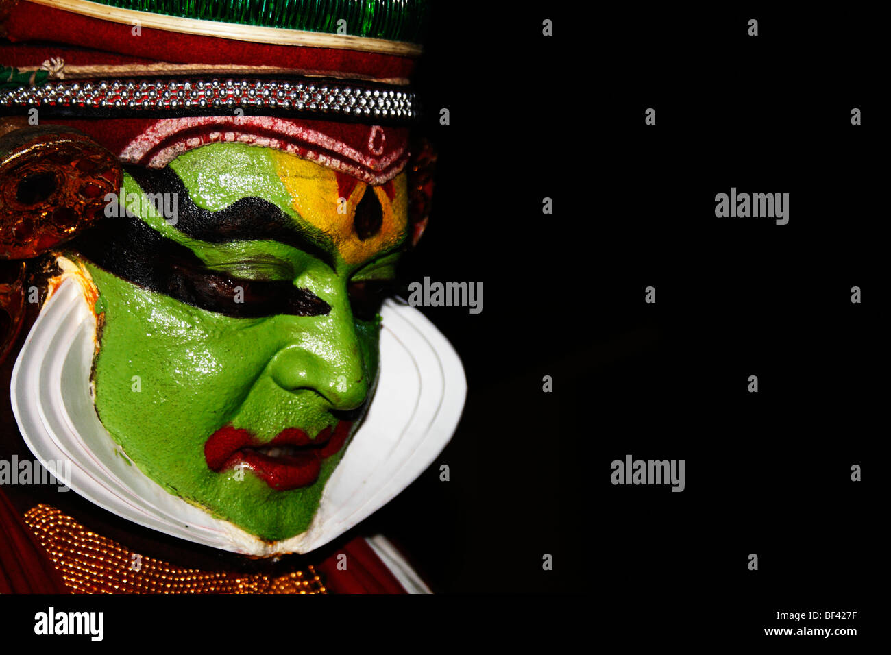 side view,face,kathakali,drama,stage show,face,expressions,colored face,dance ,play,solo,art,indian Stock Photo