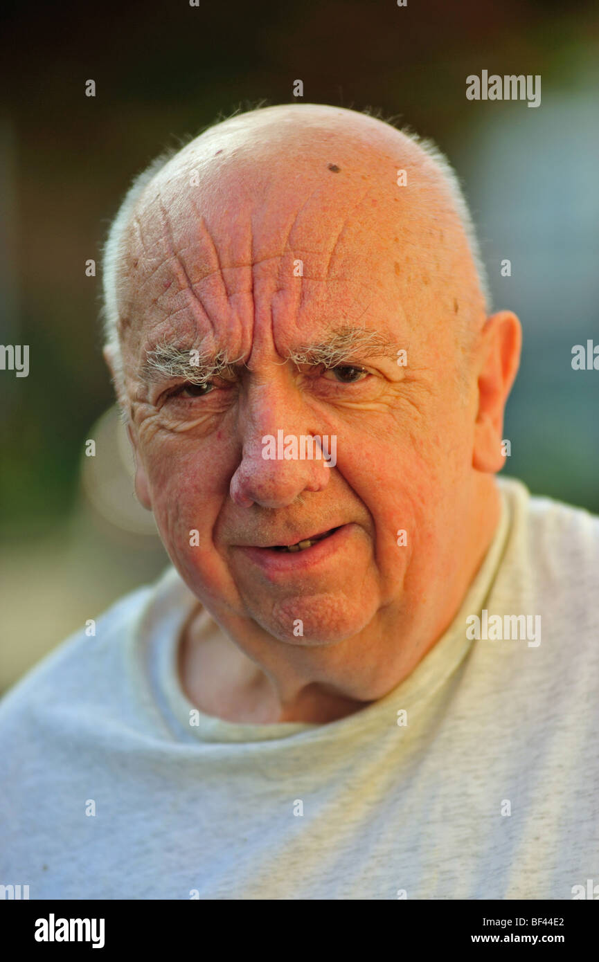 Portrait of an elderly man standing outside his home Stock Photo