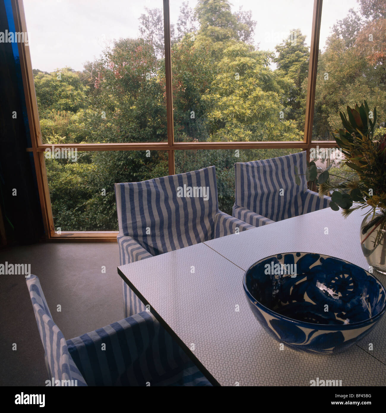 Blue+white striped loosecovers on director's chairs in modern dining