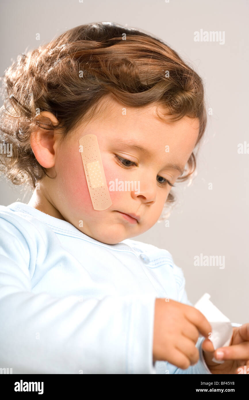 Injured toddler with bandage in his face Stock Photo Alamy