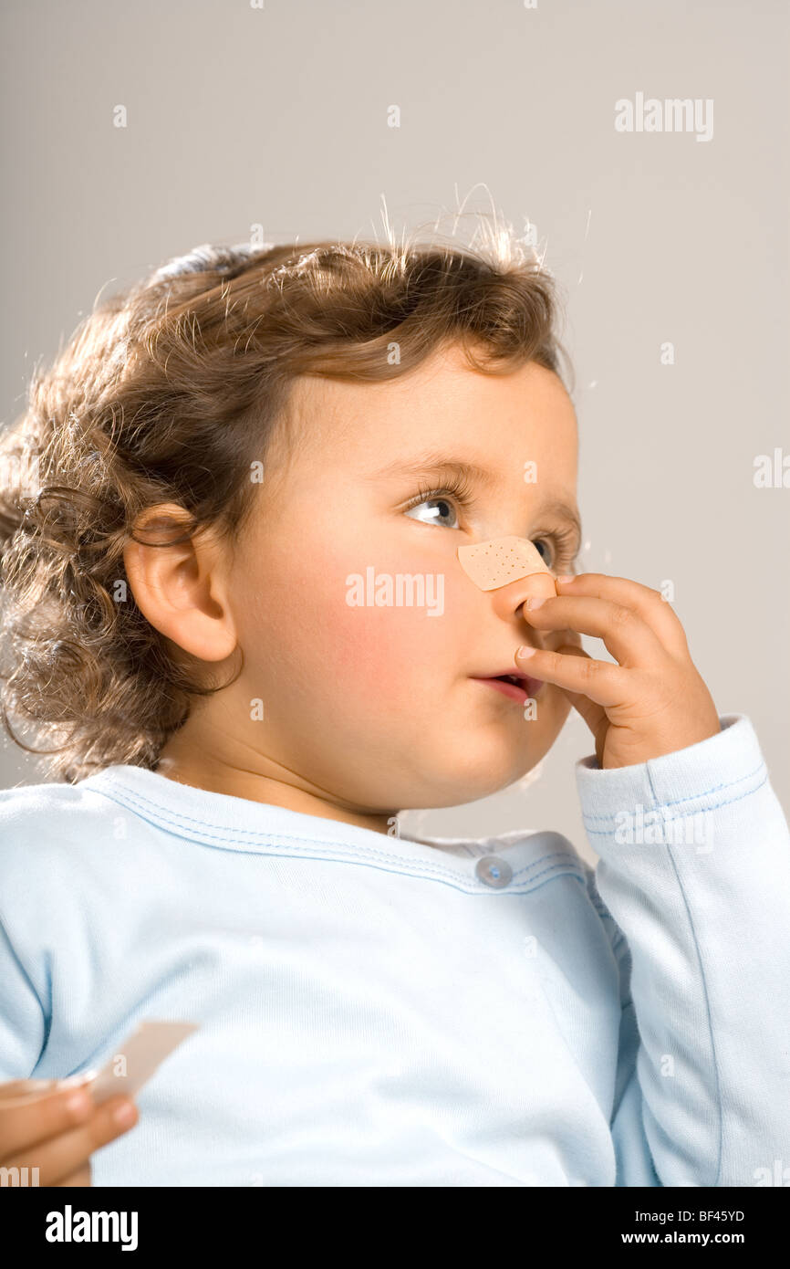 Injured toddler with bandage in his nose Stock Photo Alamy