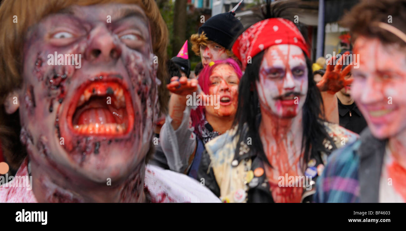 Blurred mob of bloody Zombies attacking bystander victims while having fun lurching along in the annual Toronto Zombie walk Stock Photo