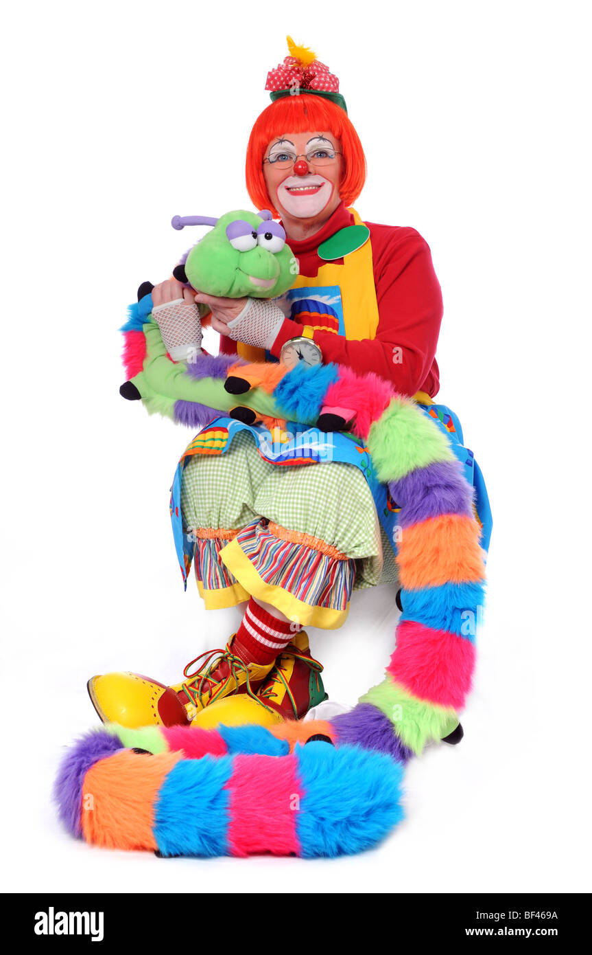 Colorful clown sitting with pet worm Stock Photo