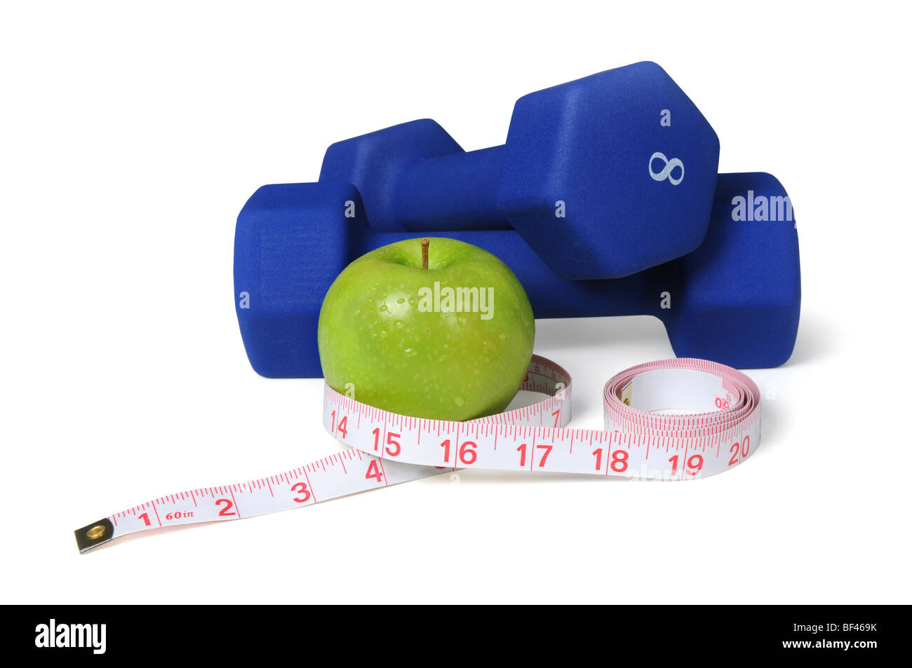 Dumbbells, measuring tape and apple isolated over a white background Stock Photo