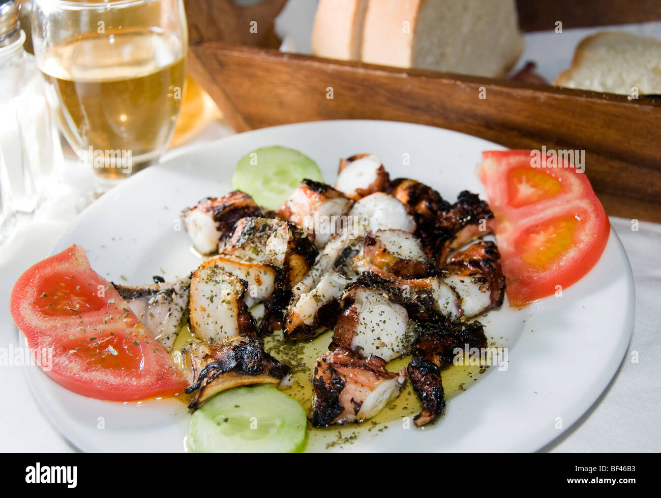 greece greek food octopus restaurant taverna grilled marinated plate specialty photograph santorini table wine home made house w Stock Photo