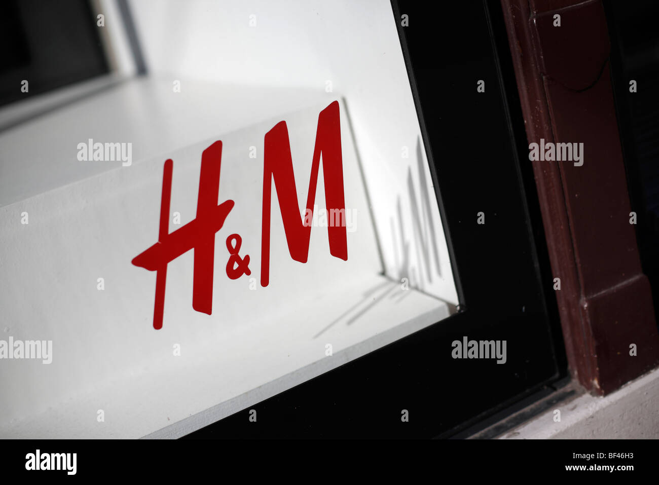The logo for the fashion retail company H&M in a store window in Graz ...