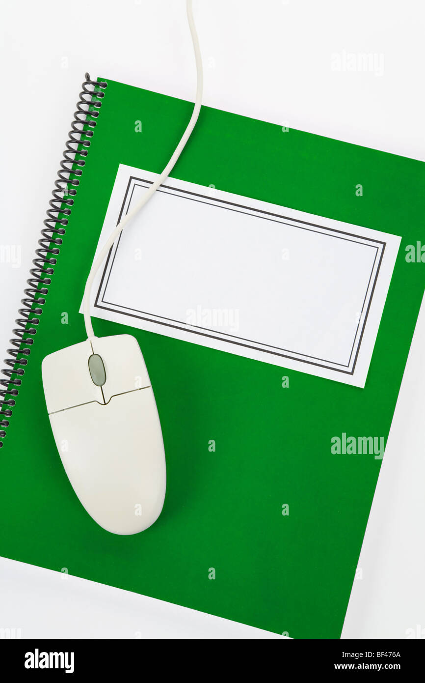 Green school textbook and computer mouse, online learning Stock Photo