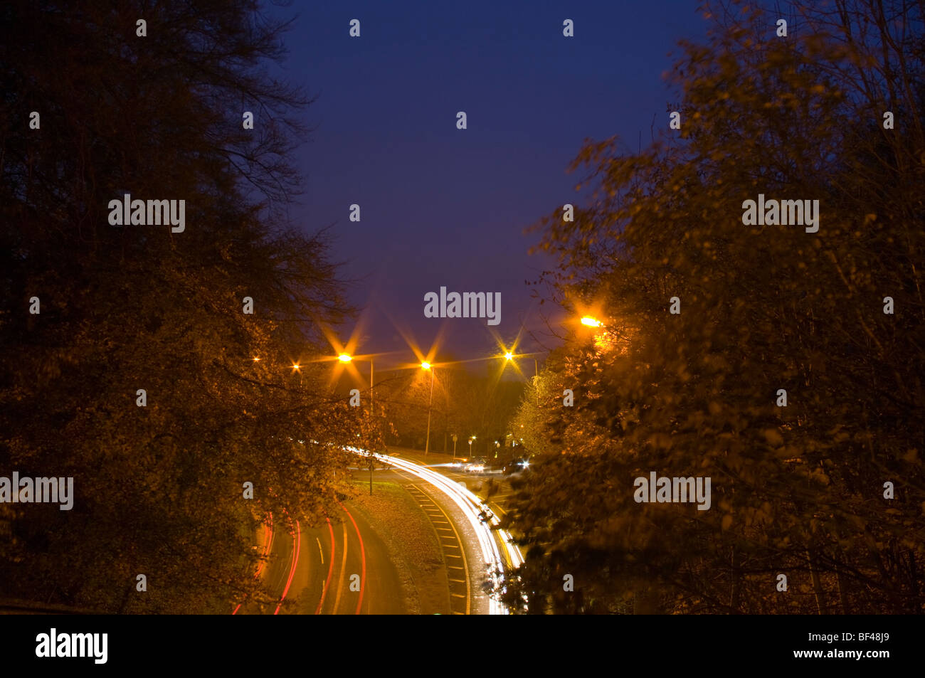 Traffic Trails headlights at night evening dusk Stock Photo