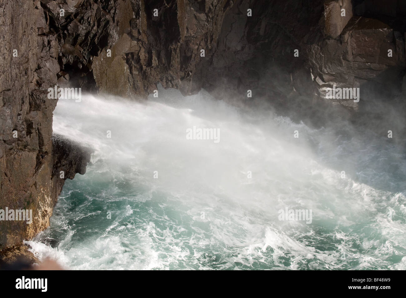 Coastal cave spraying seawater with high pressure at Eshaness, Shetland Isles Stock Photo
