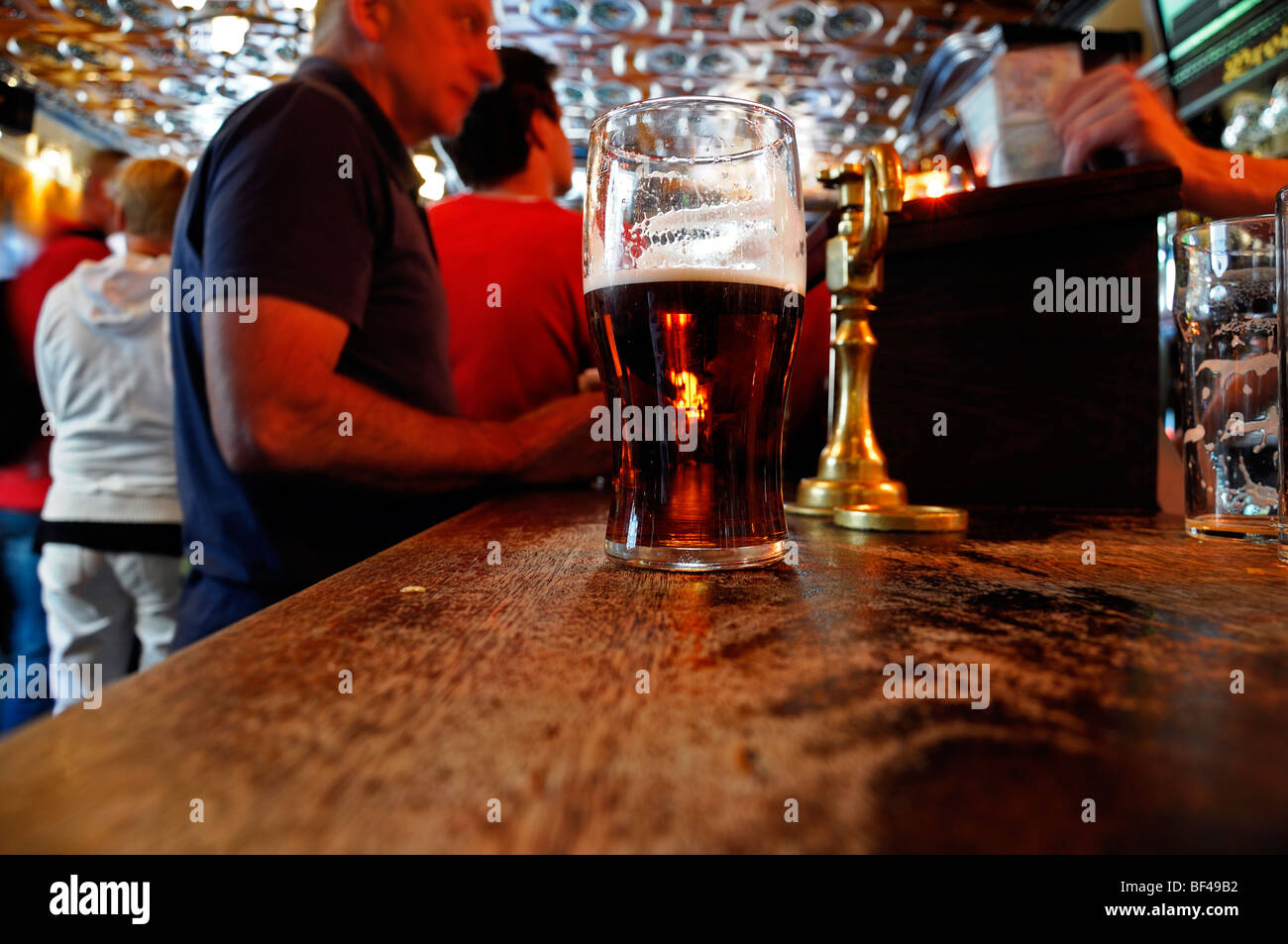 half empty full pint of beer on a bar pub licensed premises galway ireland Stock Photo