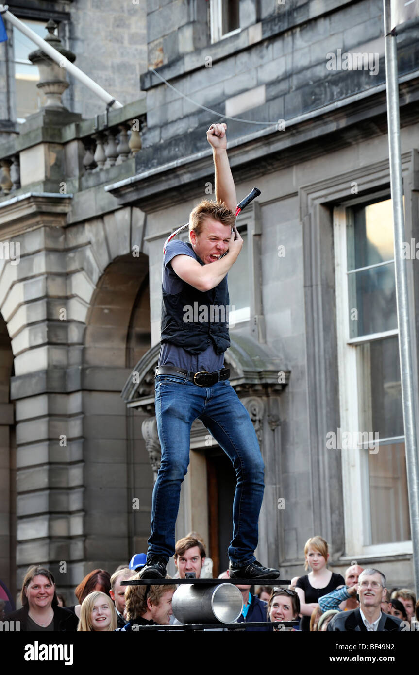 contortionist pushing his body through tennis racket balancing act balanced crowd Edinburgh