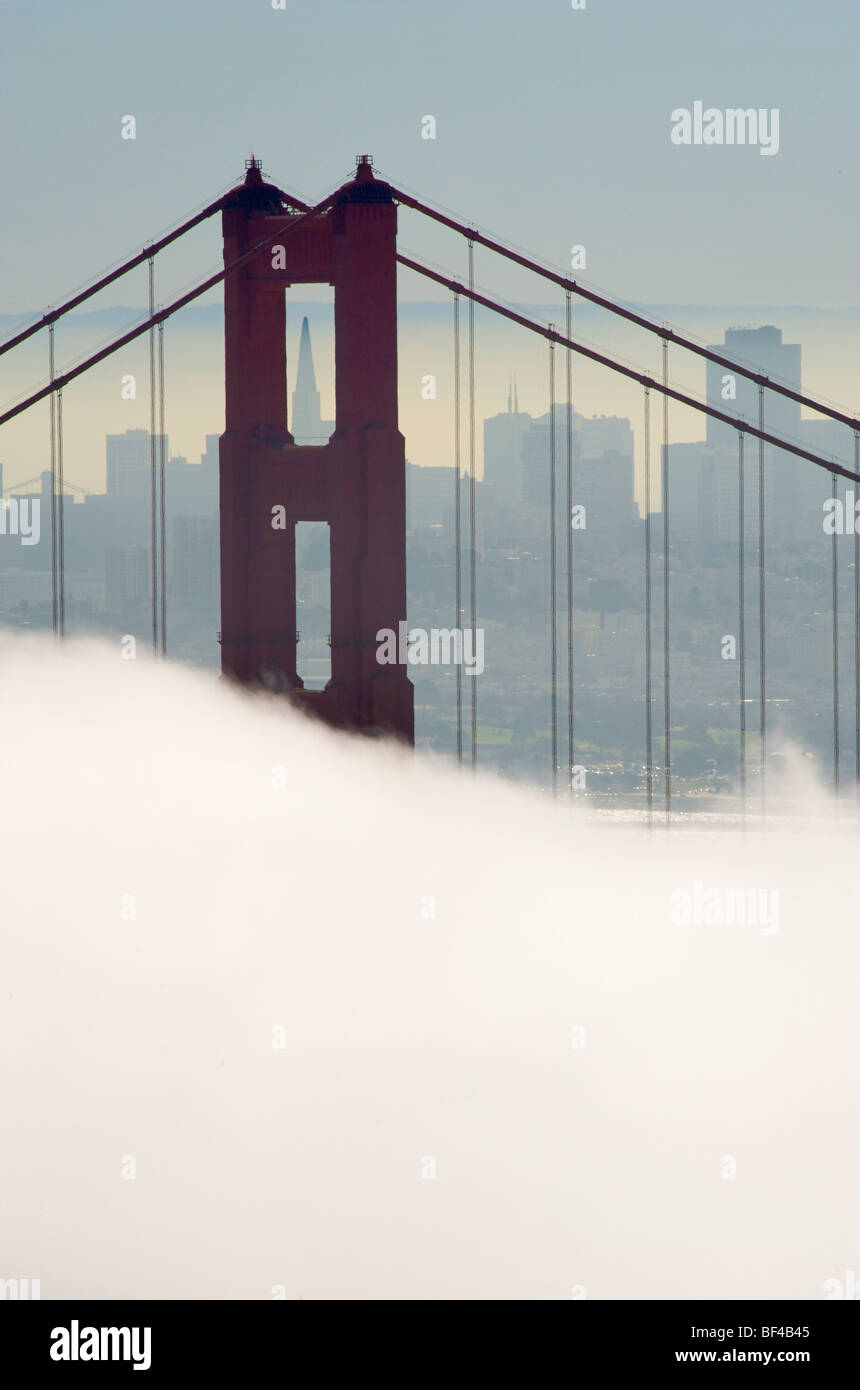 Golden Gate Bridge, half in fog, San Francisco in the back, California, USA Stock Photo