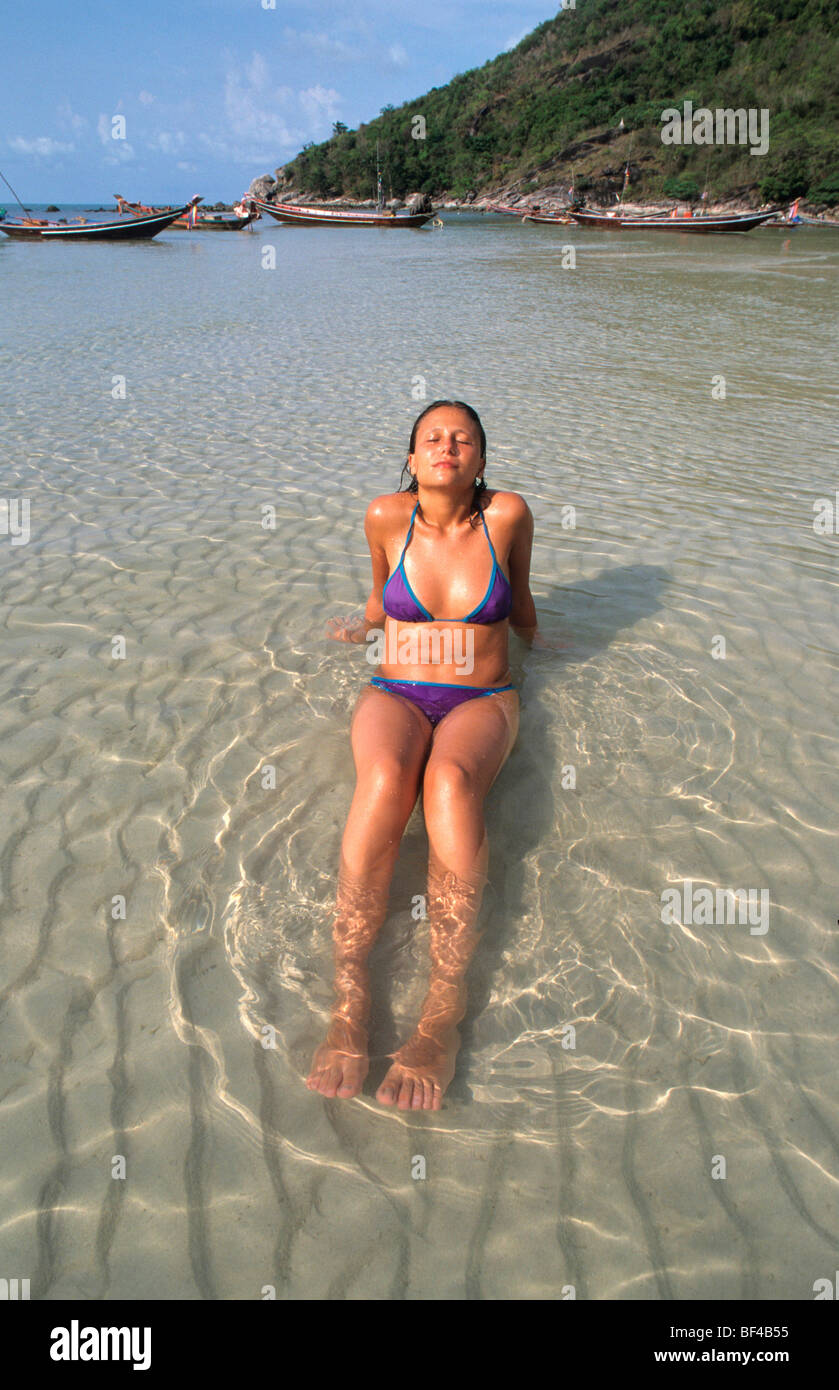 Young woman in the crystal clear waters of the bay of Tong Nai Pan, Koh Pha Ngan Island, Thailand, Asia Stock Photo
