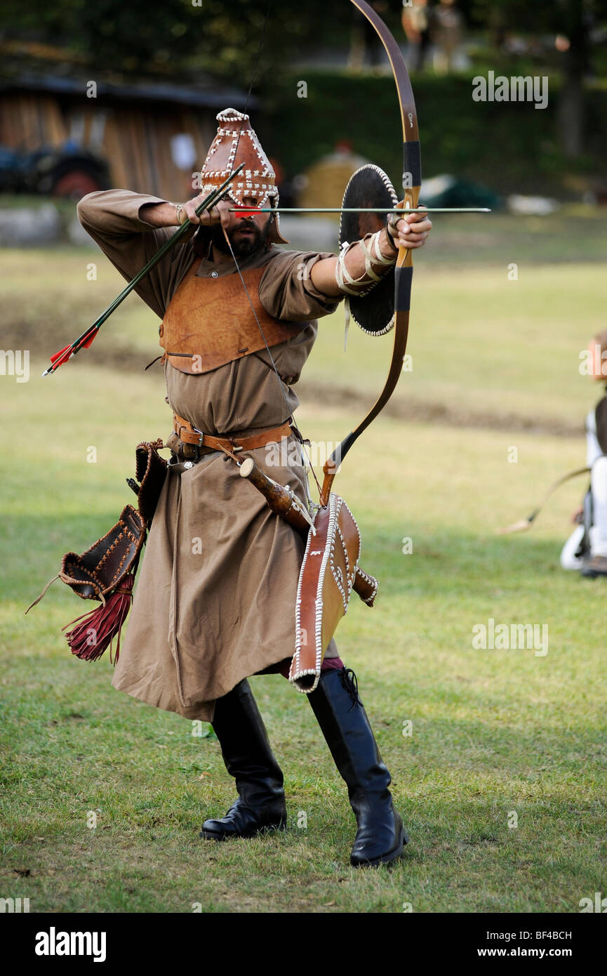 Archer demonstrating traditional fighting techniques with bow and arrow for the audience, open