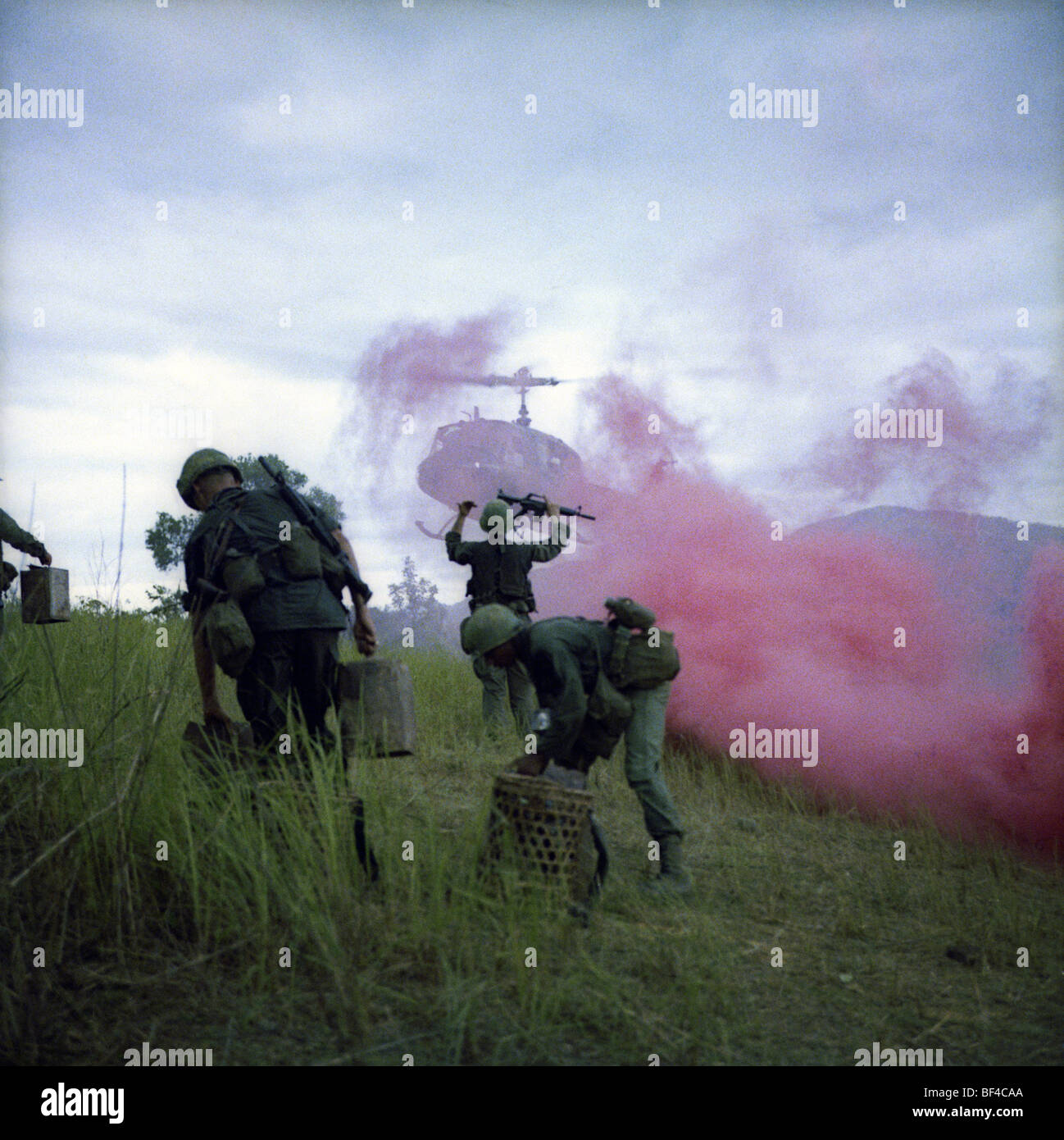 Members of B Troop, 1st Squadron, 9th Cavalry pop red smoke grenade during a huey helicopter extraction while on patrol. Stock Photo