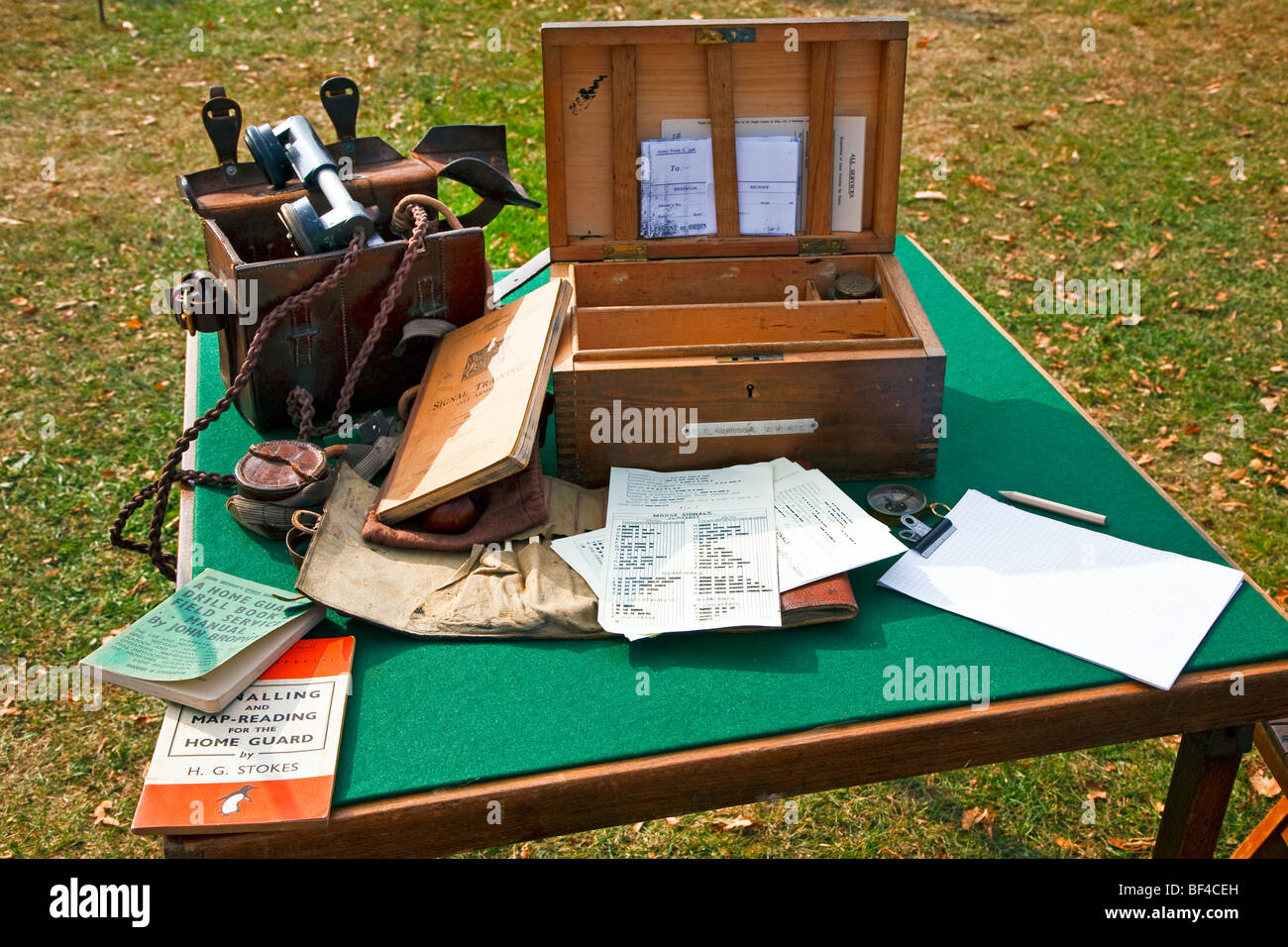 Home Guard war memorabilia displaying a field phone and signal manuals on a table at Goodwood west Sussex, Engand, UK 2009 Stock Photo