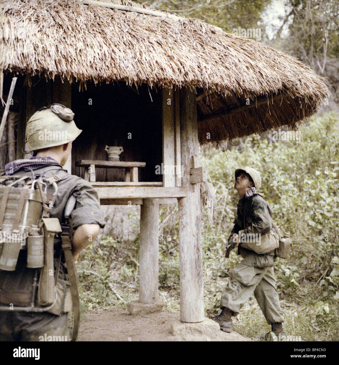 Infantrymen of B Troop, 1st Squadron, 9th Cavalry check out a shrine while on patrol during the Vietnam War in 1967. Stock Photo