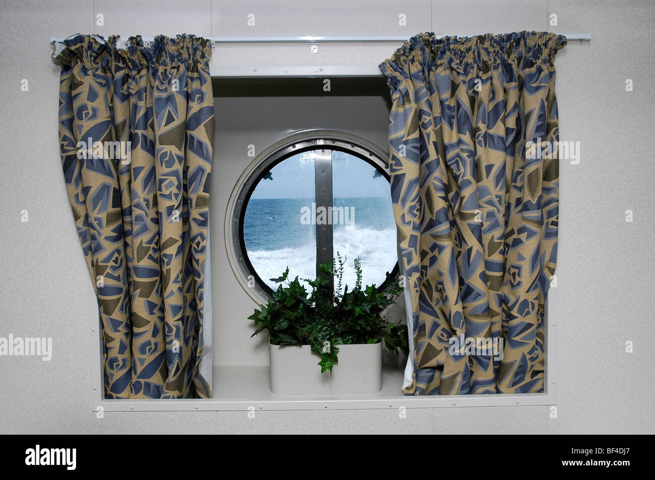 Stormy sea seen through port hole, Queen Mary 2 cruise ship Stock Photo