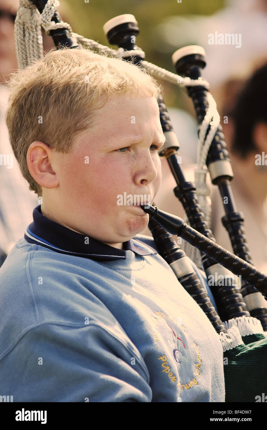 Scottish boy playing bagpipe during parade Stock Photo Alamy