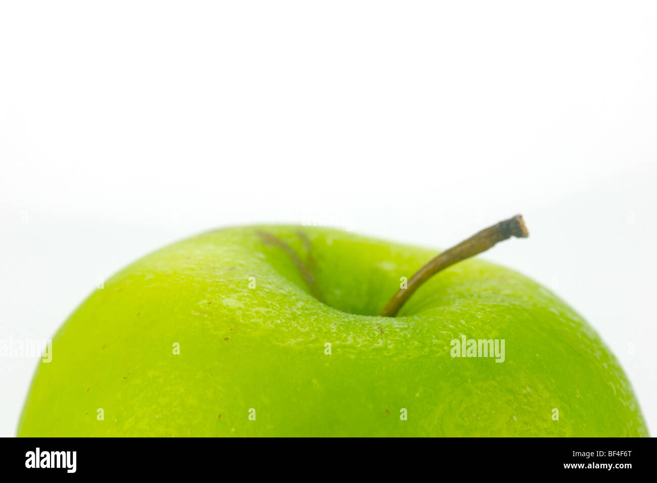 A green apple isolated against a white background Stock Photo - Alamy